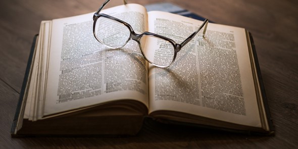 Glasses on top of open book