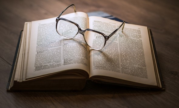 Glasses on top of open book